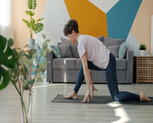 Person taking a break to stretch gently in living room