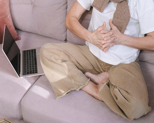 Person observing their posture while sitting comfortably at home